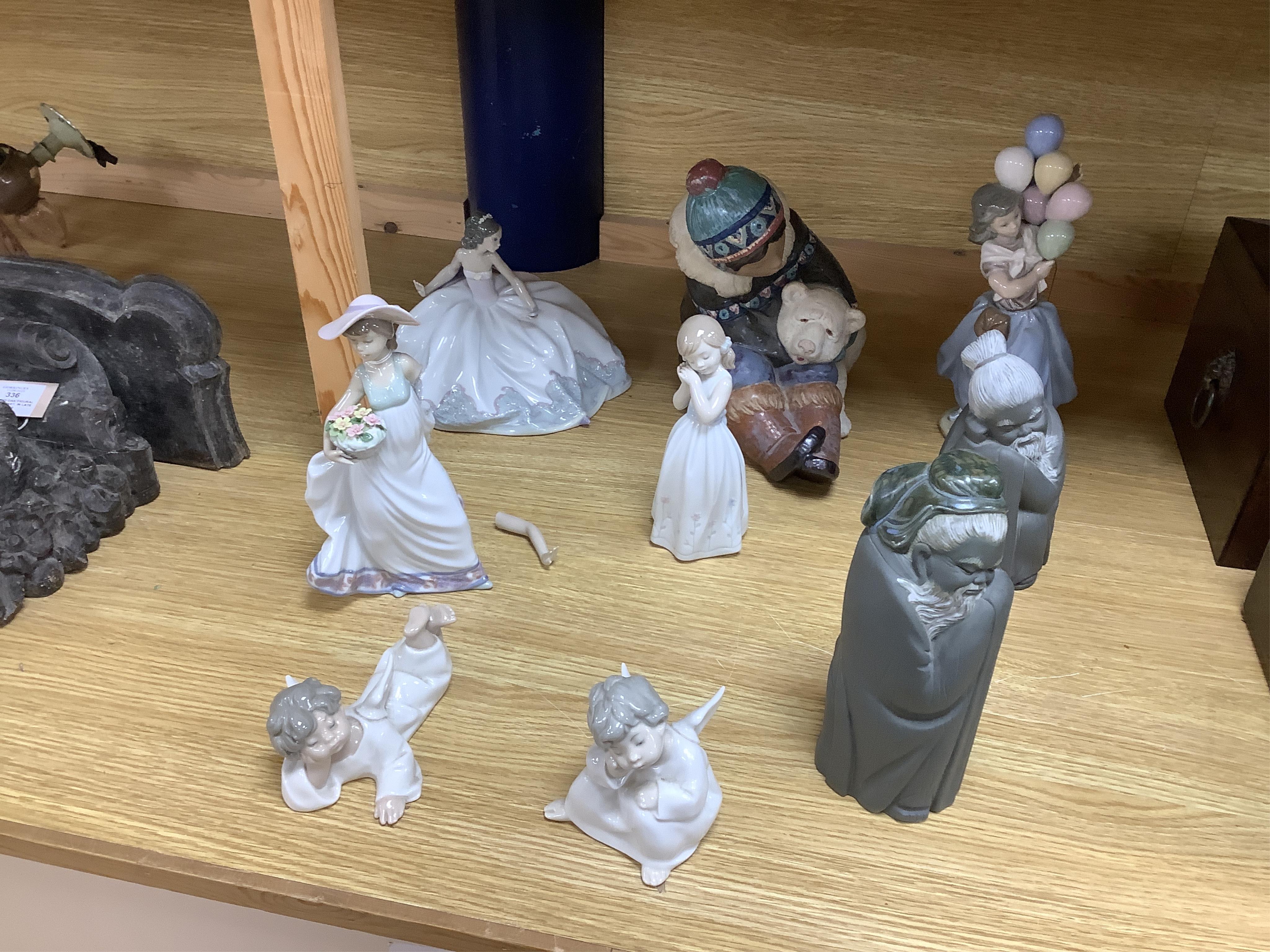 A collection of Lladro to including an eskimo and polar bear group, 23cm high (9)